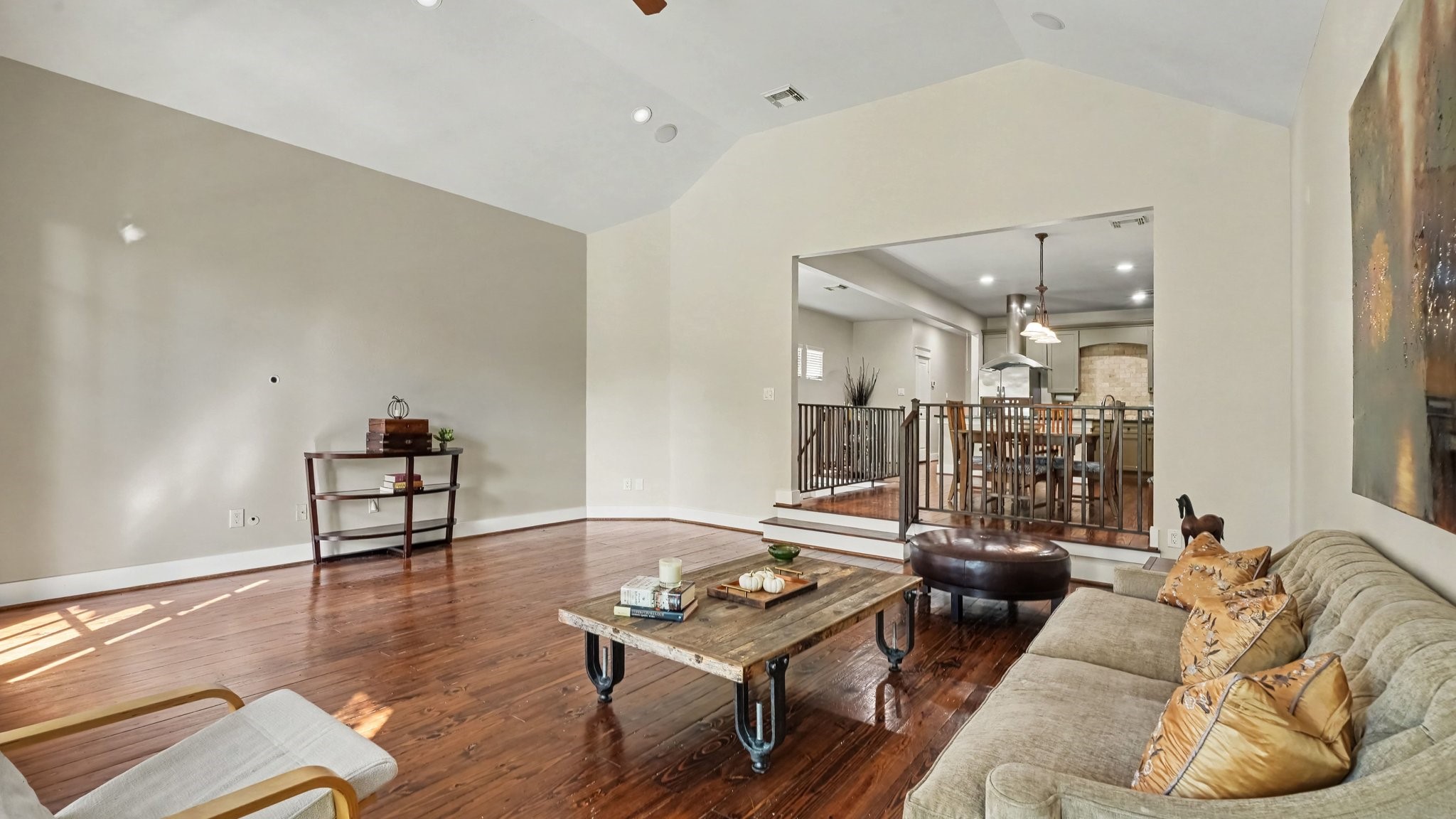 One more view of the living room that highlights the high ceilings and two steps that easily flow into the dining room and kitchen