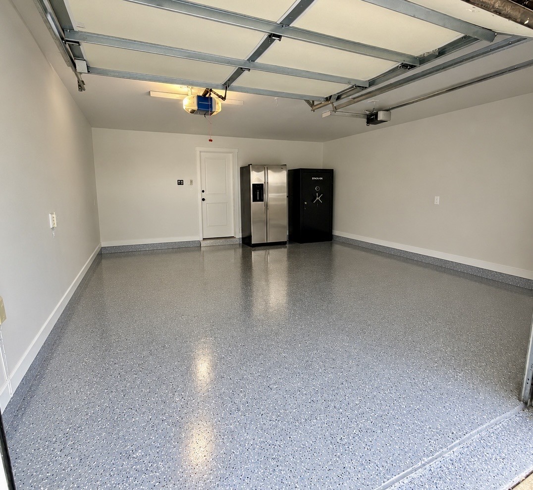 Two car garage with brand new epoxy floor.  Pictured here, refrigerator and safe included!