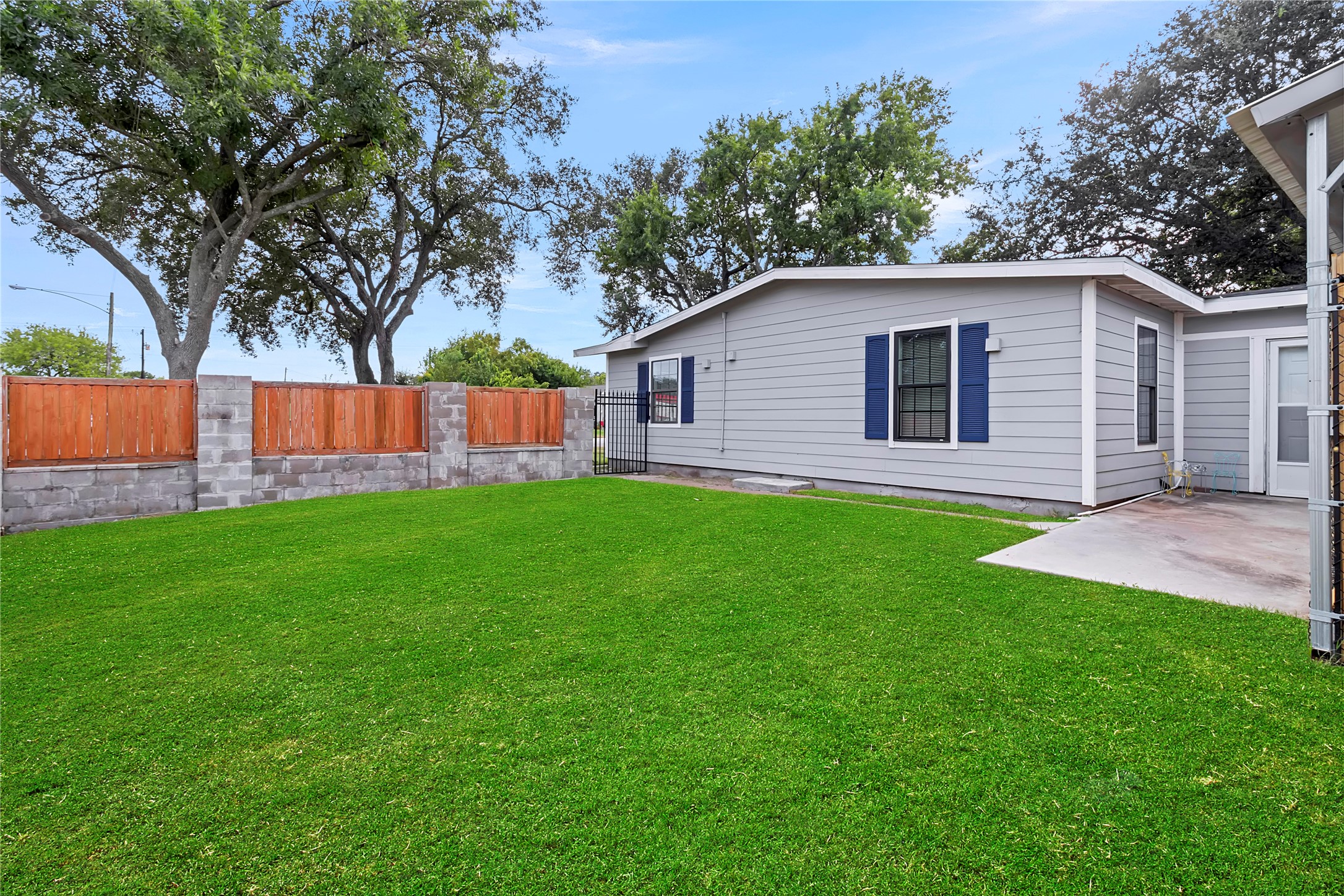 Spacious backyard surrounded by privacy fencing, providing plenty of room for outdoor living, pets, or entertaining.