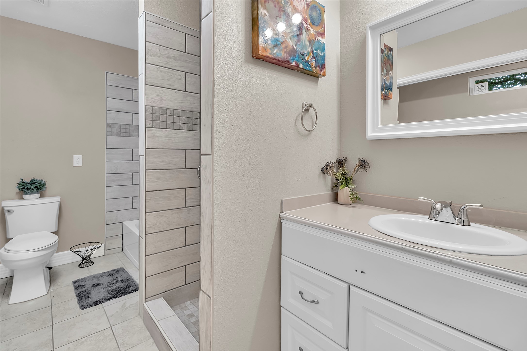 Second full bath offers attractive tile finishes and a unique layout with two separate shower areas for added convenience.