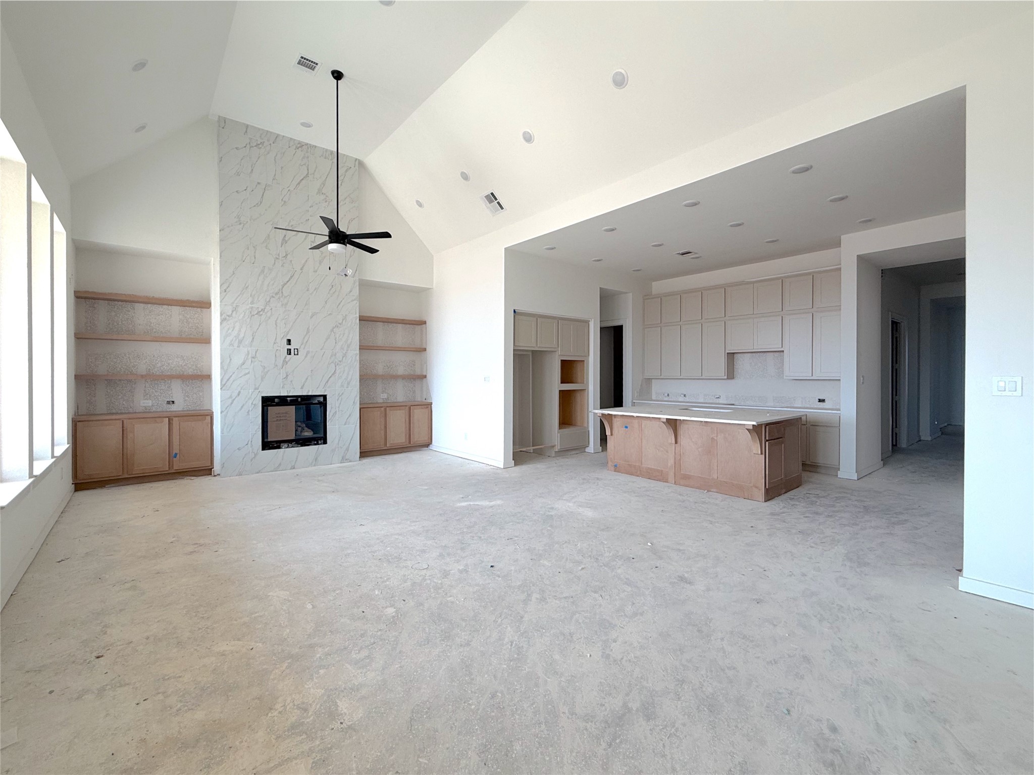 Inviting living area with cozy fireplace and seamless flow to the kitchen Inviting living area with cozy fireplace and seamless flow to the kitchen