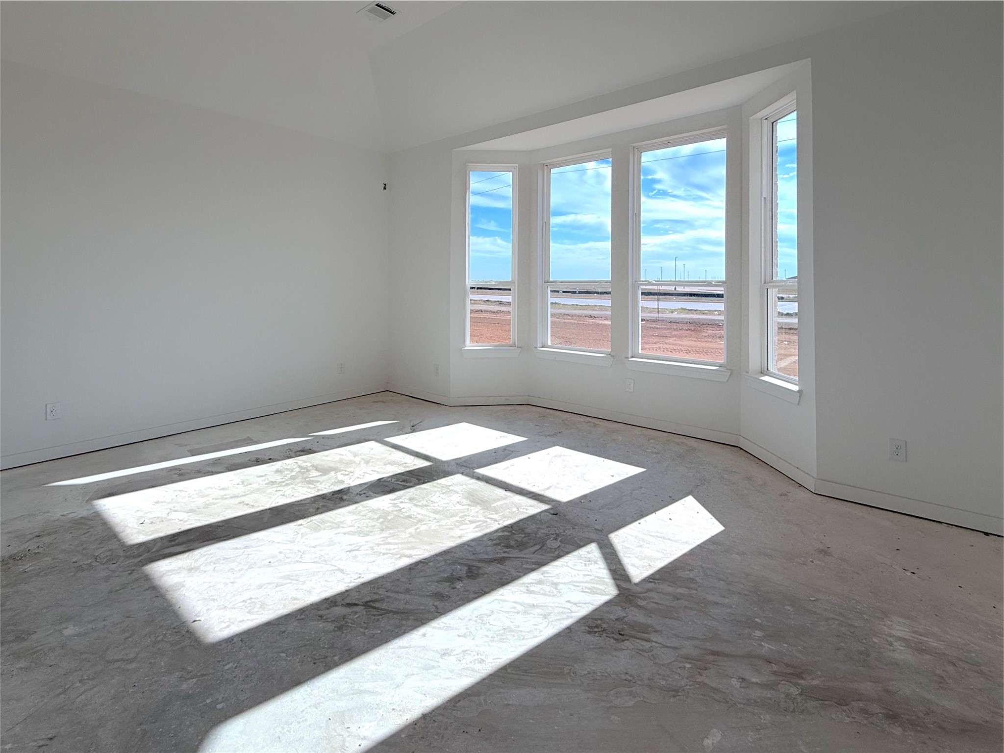 Ample space in the primary bedroom featuring a bay window with lots of natural light. Ample space in the primary bedroom featuring a bay window with lots of natural light.