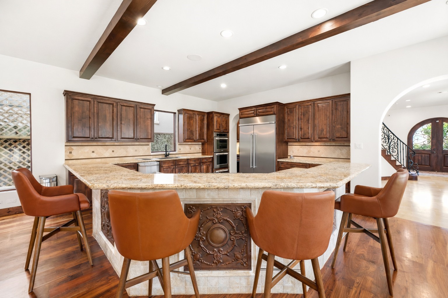 The kitchen is anchored by a high-end, built-in Kitchen-Aid refrigerator and custom cabinetry, providing ample storage and a refined look for the modern chef. The kitchen is anchored by a high-end, built-in Kitchen-Aid refrigerator and custom cabinetry, providing ample storage and a refined look for the modern chef.