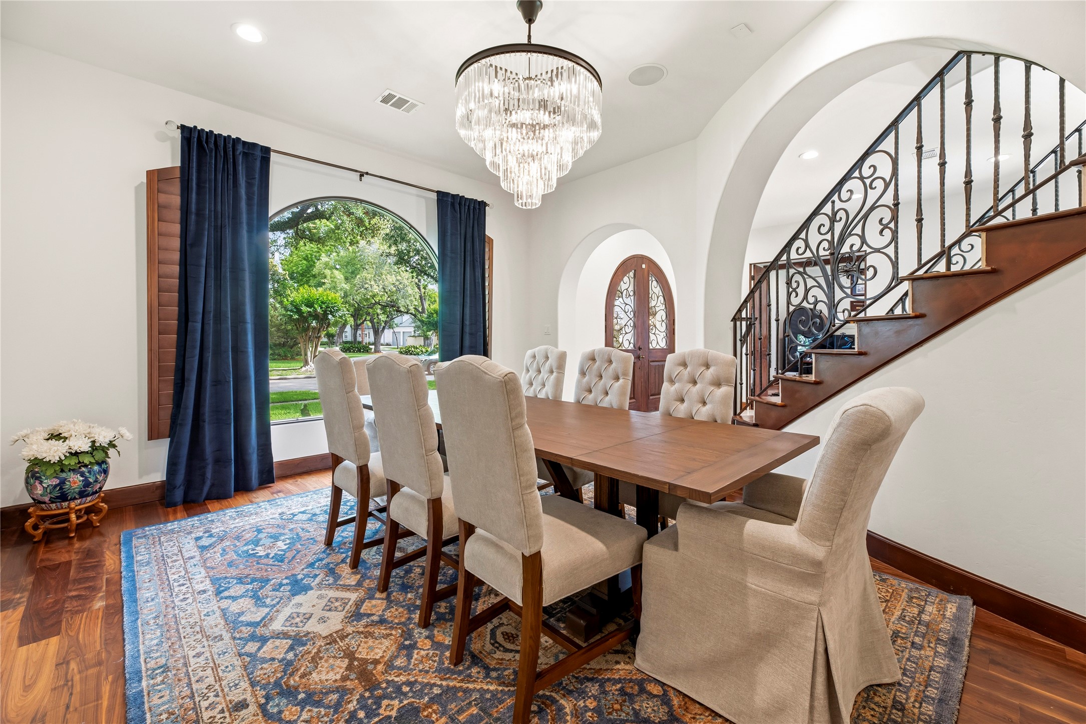 Distinguished by a designer chandelier and large arched window, this beautiful dining space creates a seamless flow for hosting formal dinners and holiday celebrations.