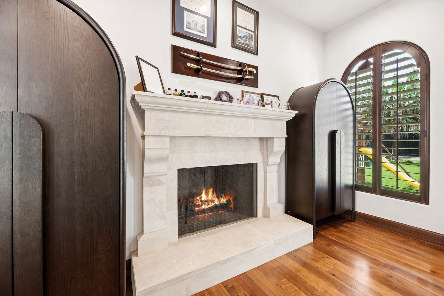 A second gas-log fireplace with a custom stone mantel anchors the study, adding warmth and a sophisticated focal point to this versatile workspace. A second gas-log fireplace with a custom stone mantel anchors the study, adding warmth and a sophisticated focal point to this versatile workspace.