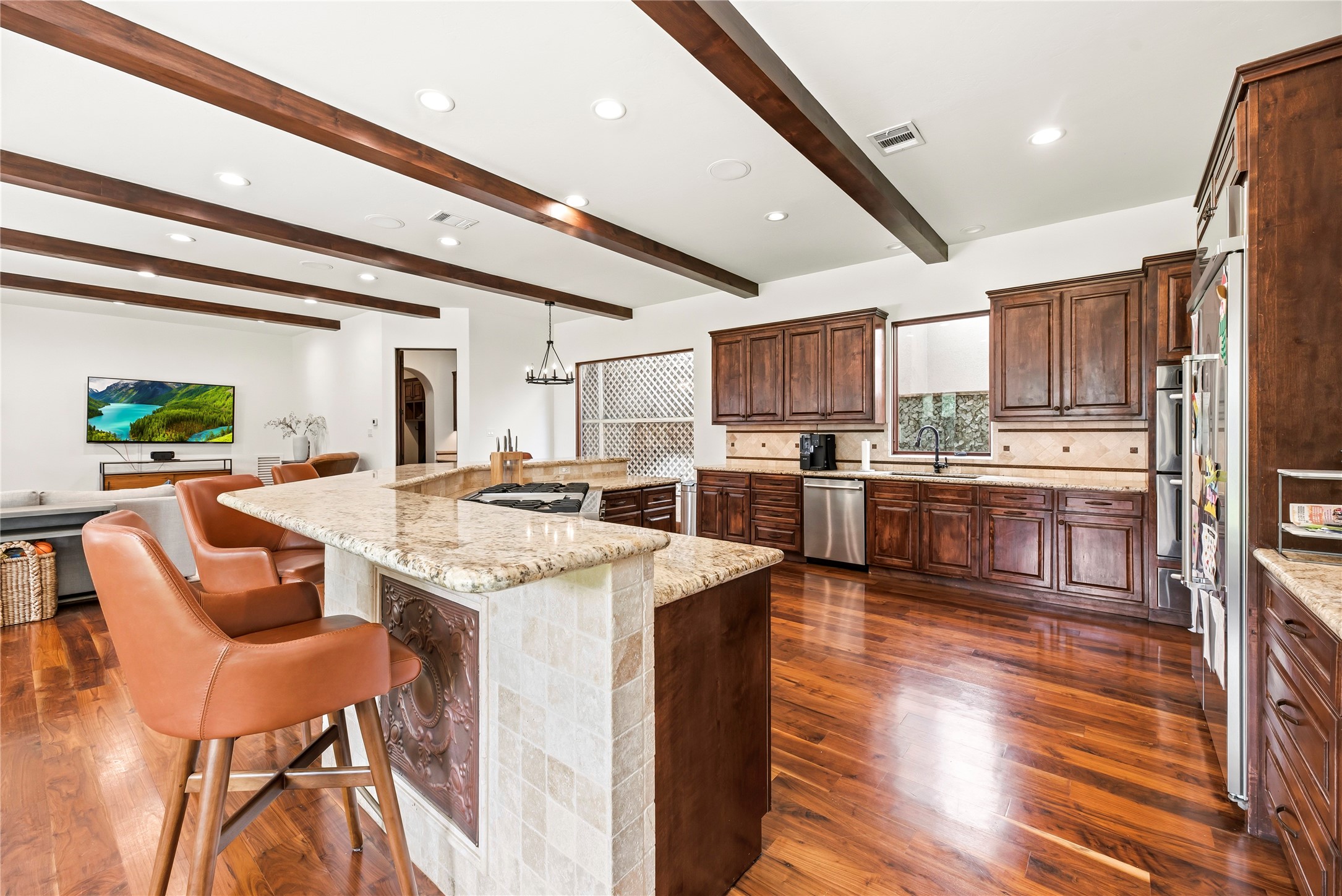 This chef-inspired kitchen features premium granite, a high-end gas range with griddle, and double ovens, perfectly blending professional-grade utility with sophisticated style.