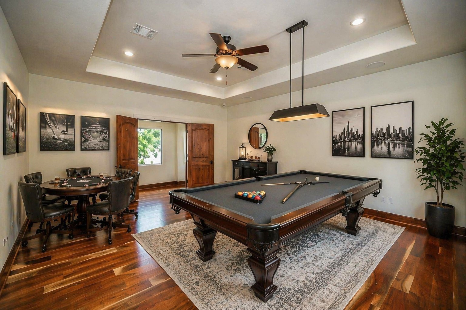 This expansive upstairs gameroom is defined by elegant tray ceilings and custom shutters, featuring grand double-door entry that opens to a flexible sanctuary for play or media entertainment. Virtually staged.