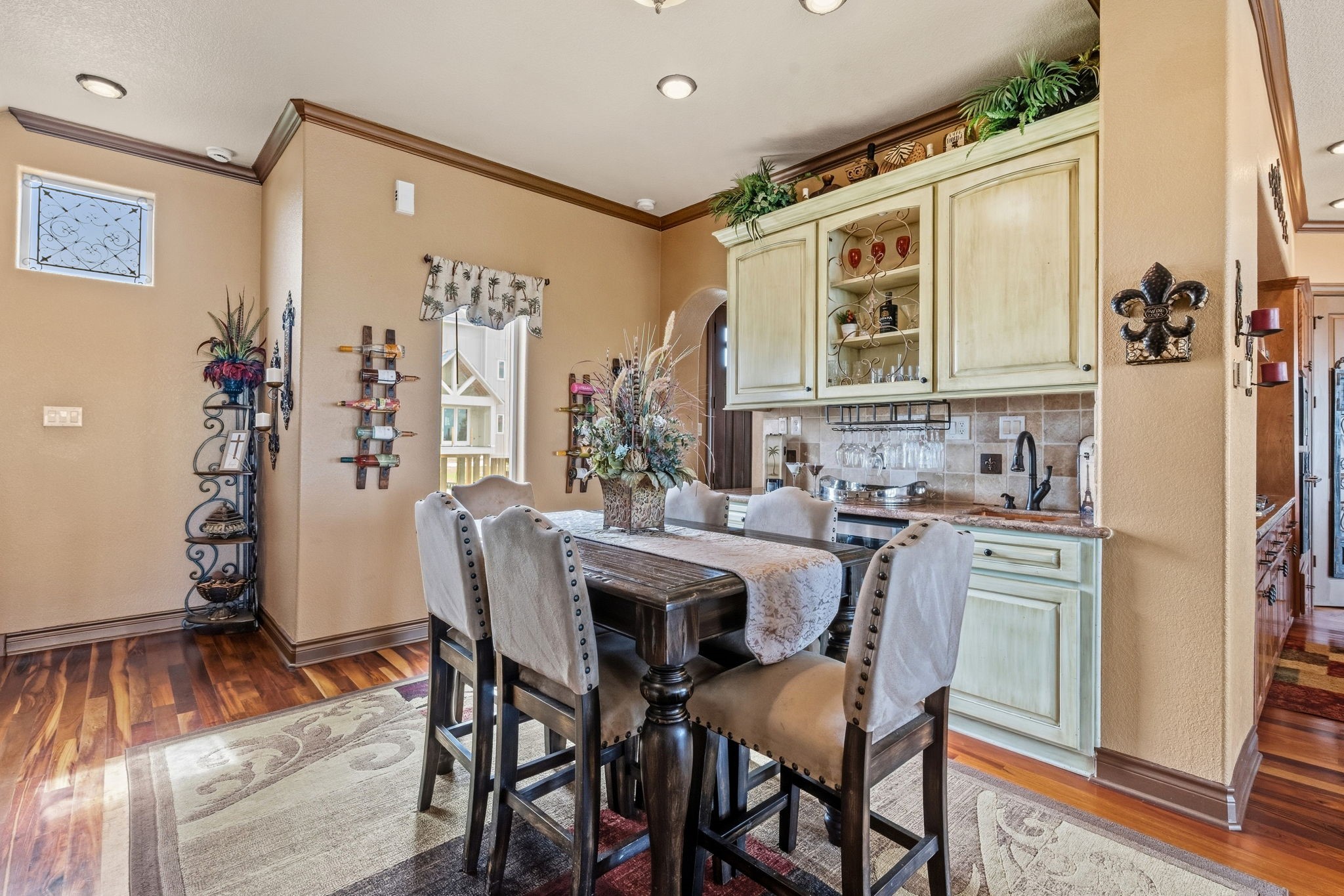 Charming dining area with elegant cabinetry, cozy seating, and warm hardwood floors, perfect for intimate gatherings.