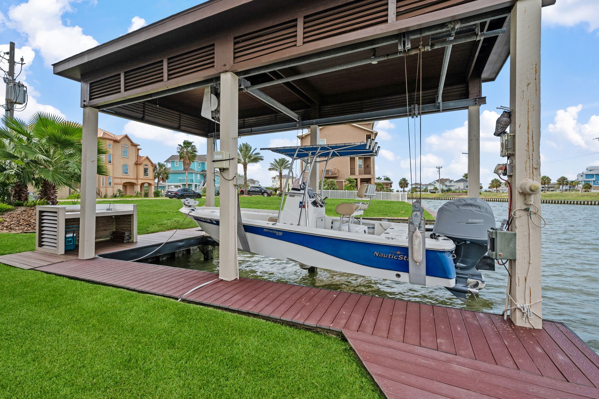 Charming waterfront property features a covered boat lift on a serene canal, providing easy access for boating enthusiasts.