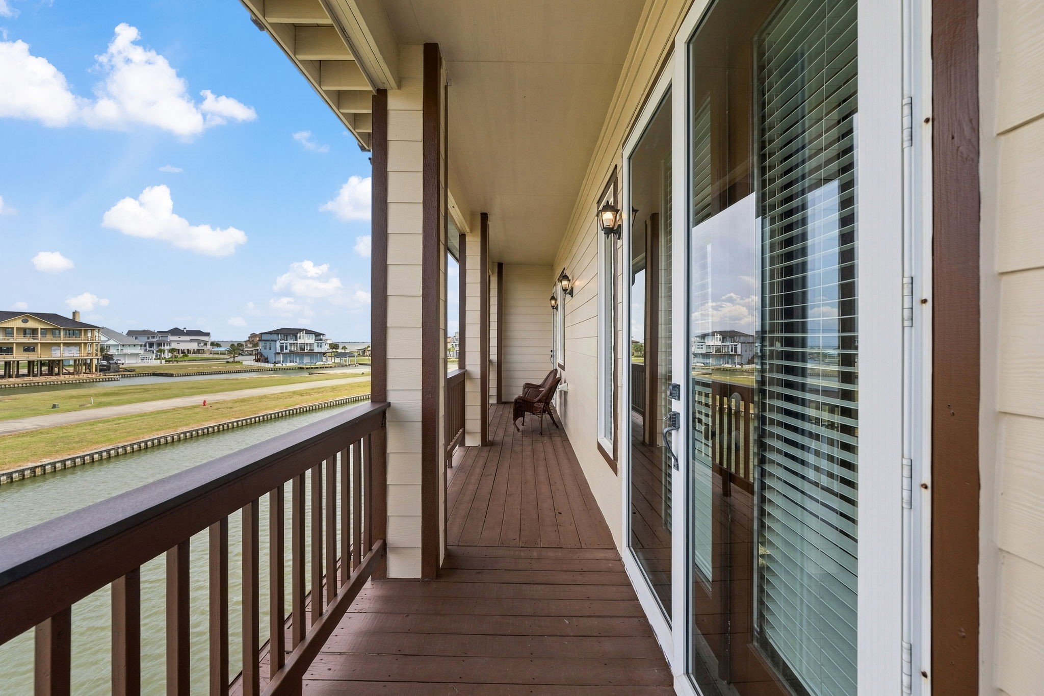 Enjoy serene waterfront views from this spacious balcony, perfect for relaxing and soaking up the coastal atmosphere.