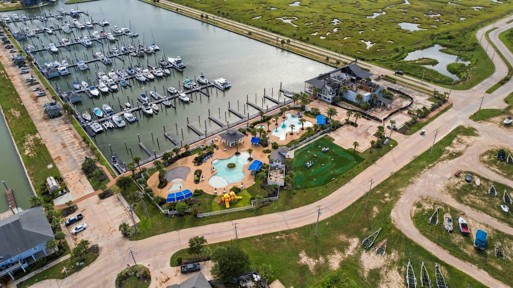 Experience waterfront living with a scenic marina view, featuring well-maintained docks and a vibrant recreational area complete with pools and playgrounds, all nestled within lush greenery. Experience waterfront living with a scenic marina view, featuring well-maintained docks and a vibrant recreational area complete with pools and playgrounds, all nestled within lush greenery.