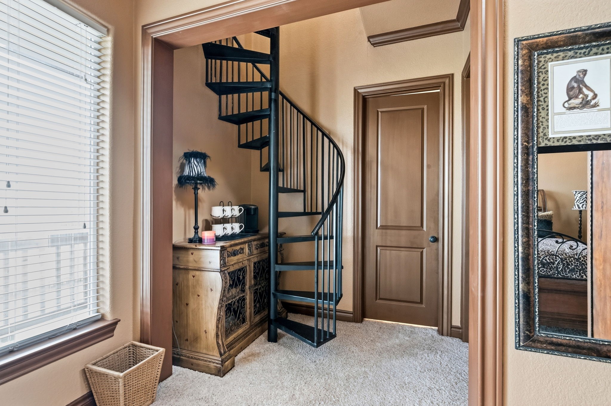 Charming nook featuring a stylish spiral staircase, warm wood accents, and natural light, offering a cozy and inviting atmosphere.