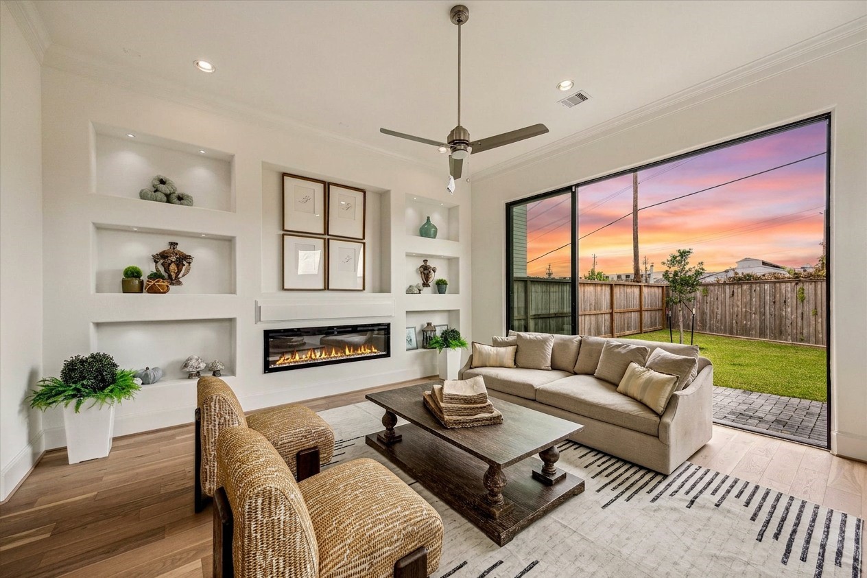 gorgeous living room area with builtins and 12 ft ceilings and large sliding glass door 10ft tall for seamless indoor/outdoor living
