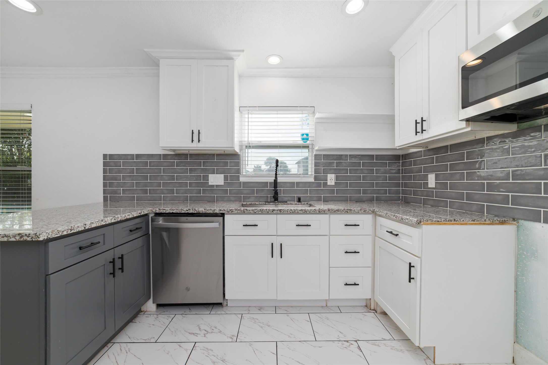 Modern kitchen with plenty of counter space and cabinets and recessed lighting.