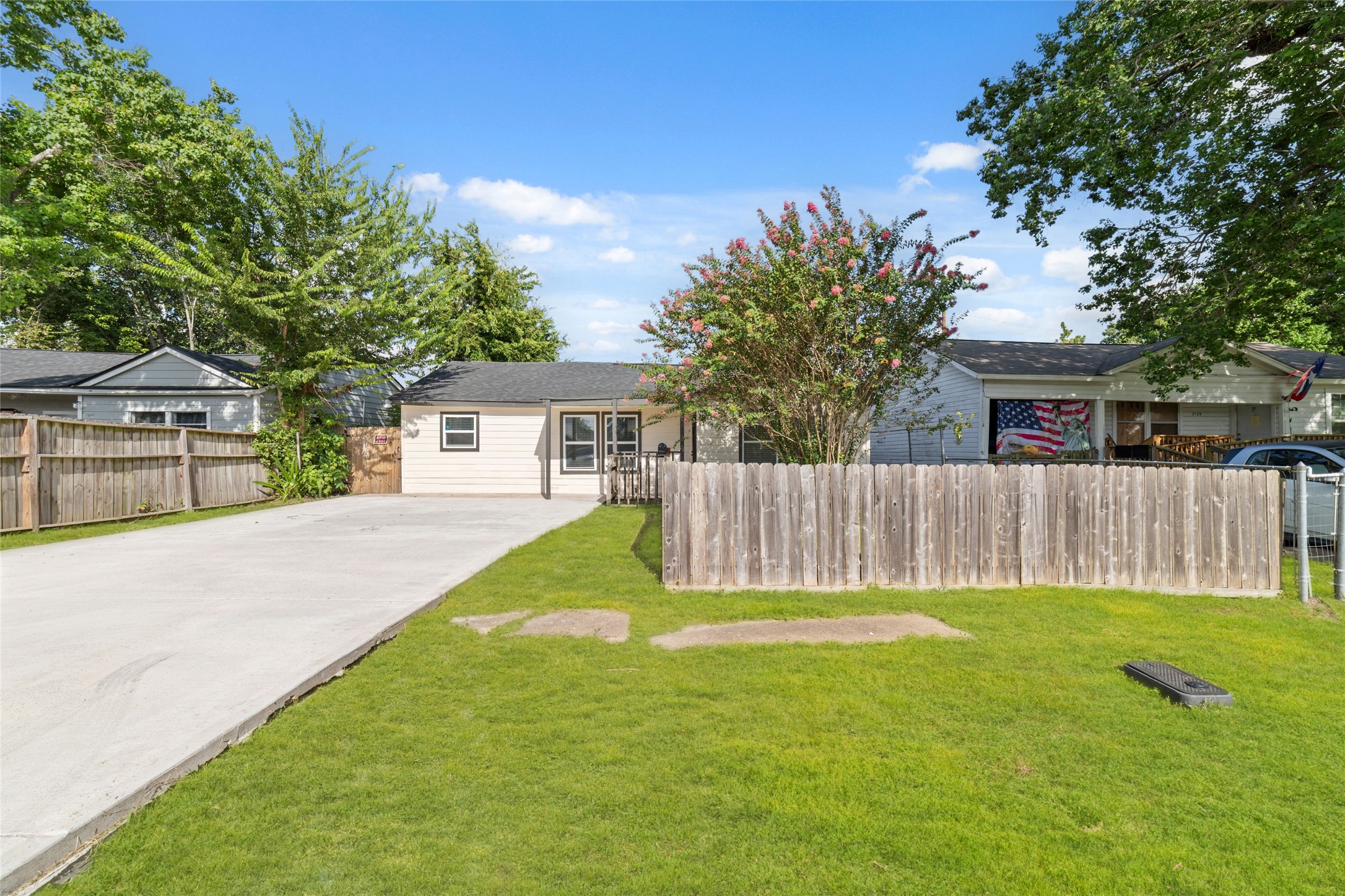 Another view of this spacious yard and long driveway that can hold 6 cars.