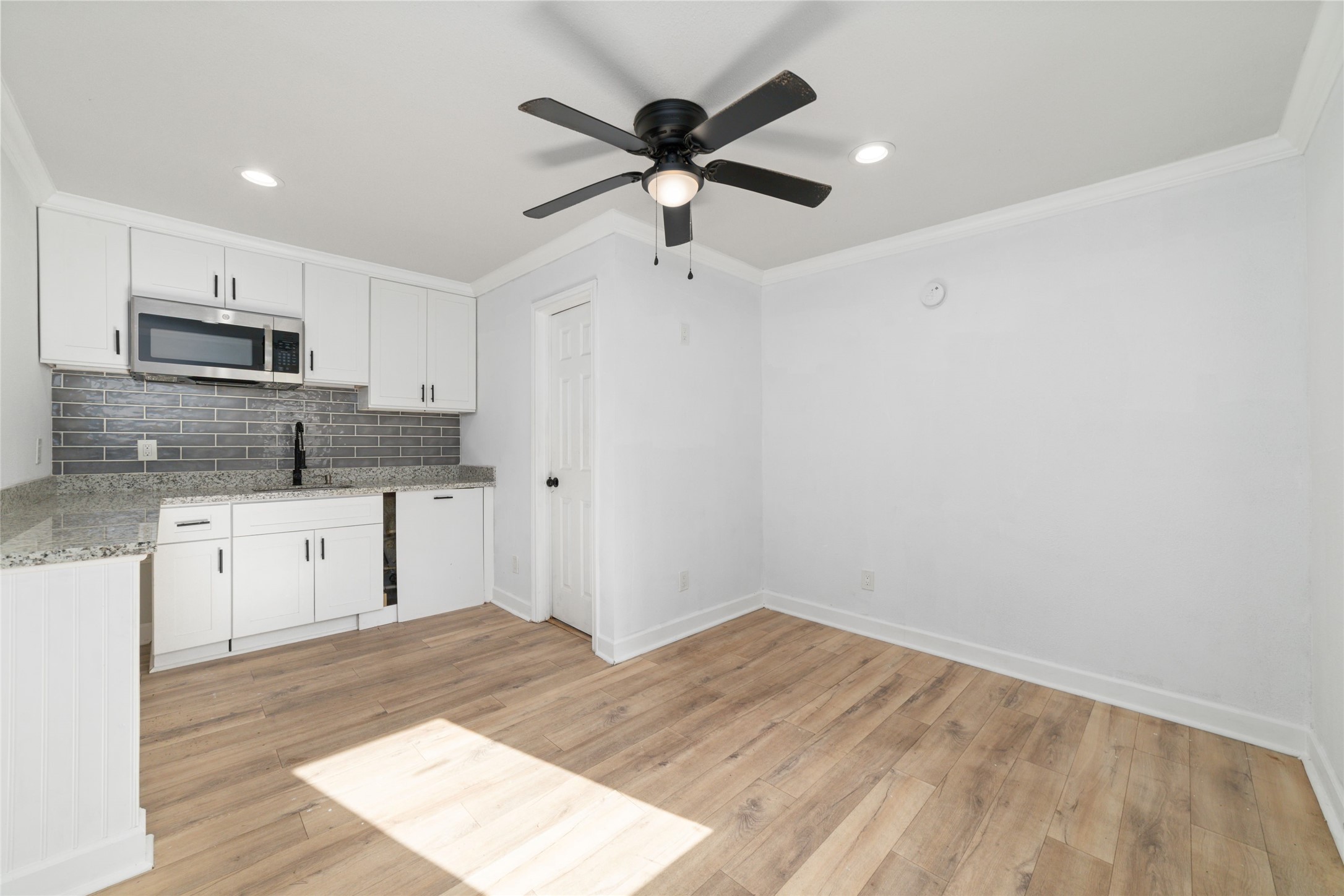 A look inside one of the dwellings that has a mini kitchen with a sink and microwave and full bathroom.