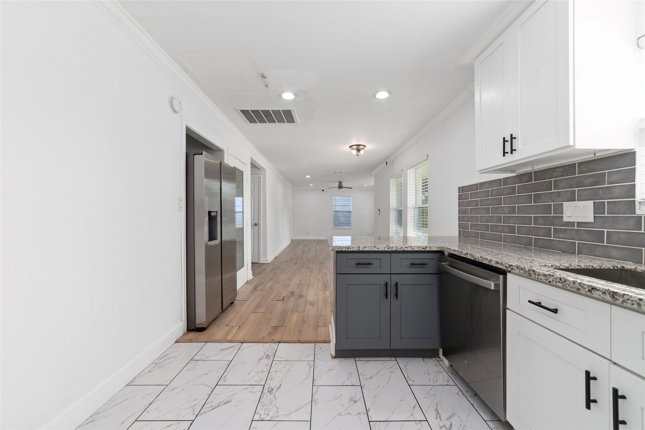 All stainless steel appliances in this kitchen including a fridge, dishwasher and microwave.
