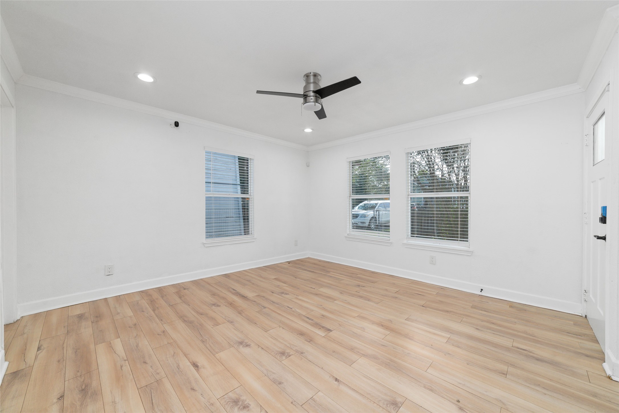 The living room has three windows that allow for ample natural light.