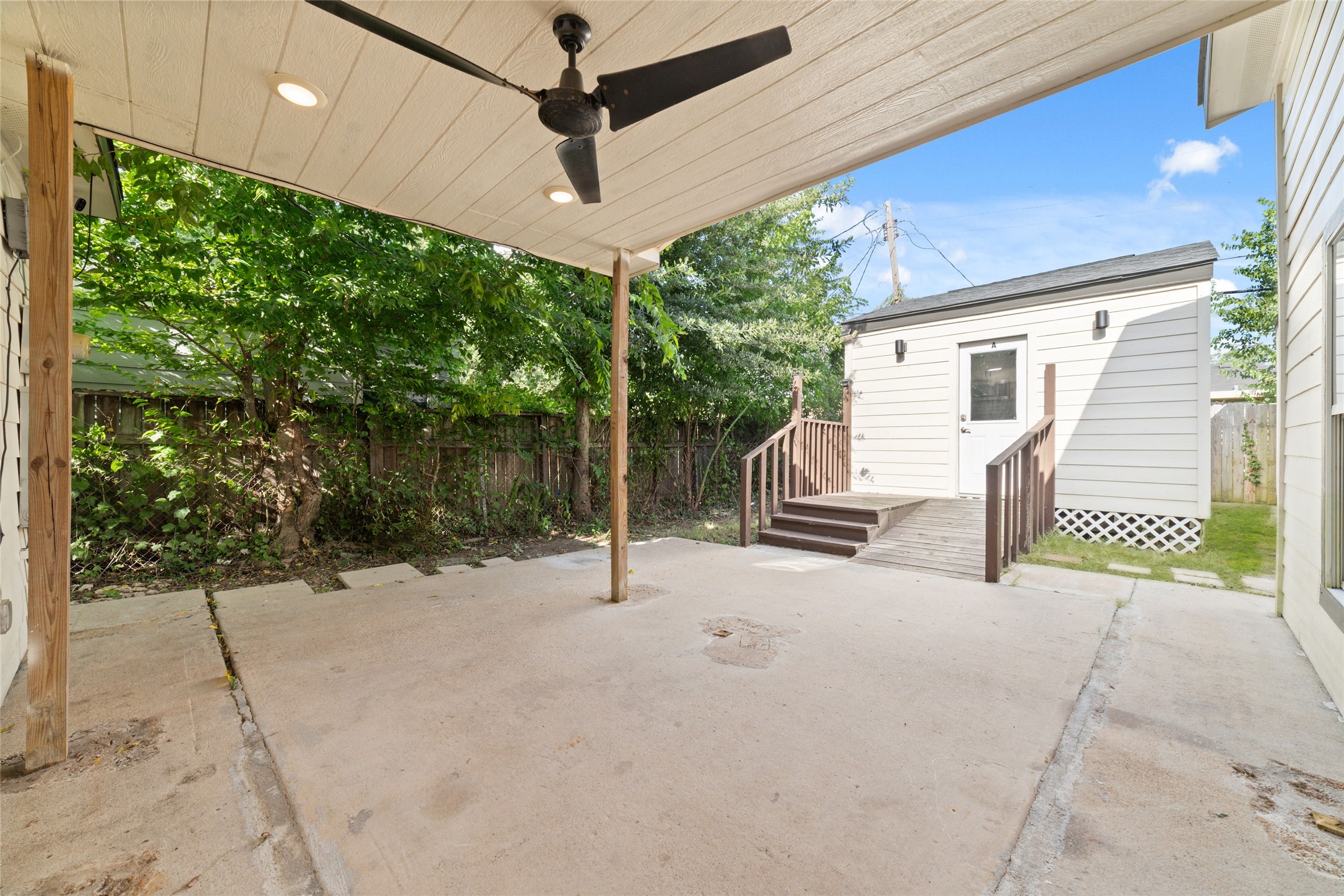 The covered patio leads to one of the two dwellings that sit side by side.
