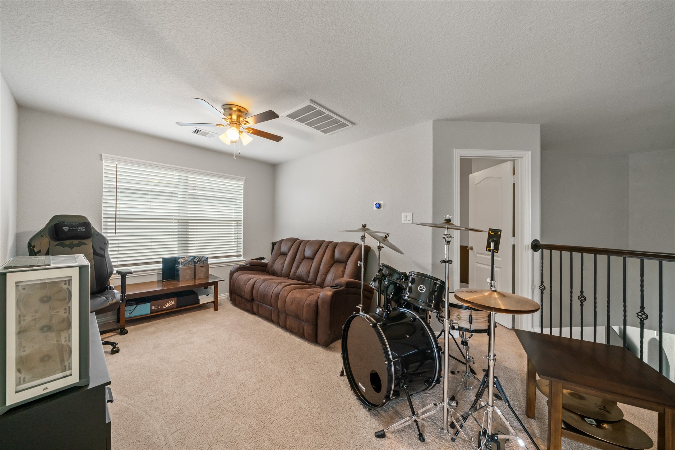 Cozy game room with plush carpeting, perfect for entertainment or relaxation.