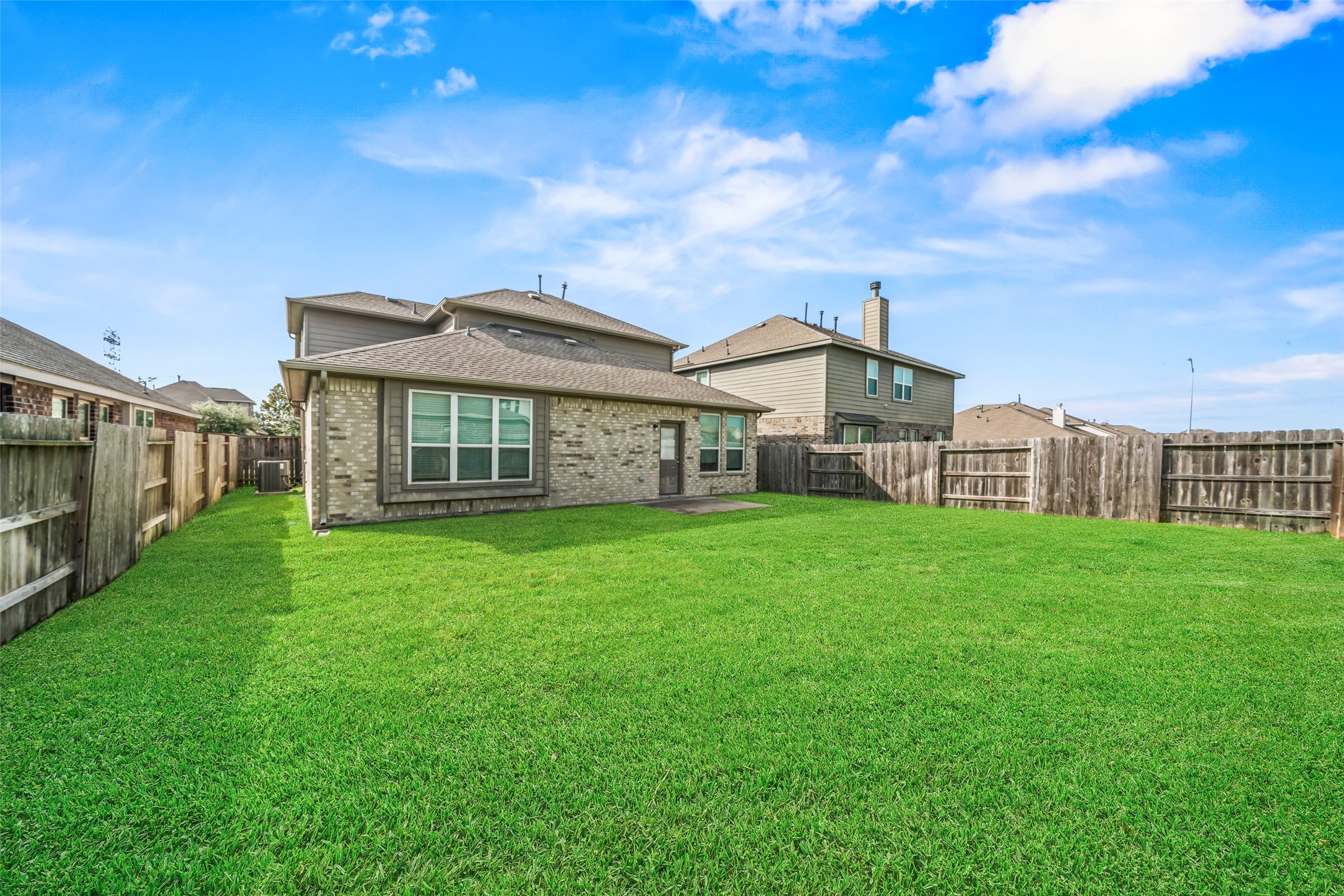 Spacious backyard with lush green lawn, perfect for outdoor activities and relaxation, enclosed by a wooden fence for added privacy. Spacious backyard with lush green lawn, perfect for outdoor activities and relaxation, enclosed by a wooden fence for added privacy.