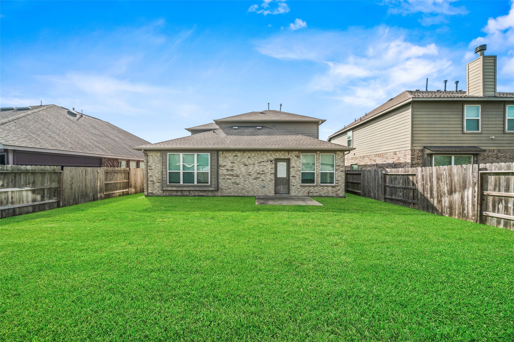 Spacious backyard with lush green lawn, bordered by a sturdy wooden fence, perfect for outdoor activities and relaxation. Spacious backyard with lush green lawn, bordered by a sturdy wooden fence, perfect for outdoor activities and relaxation.
