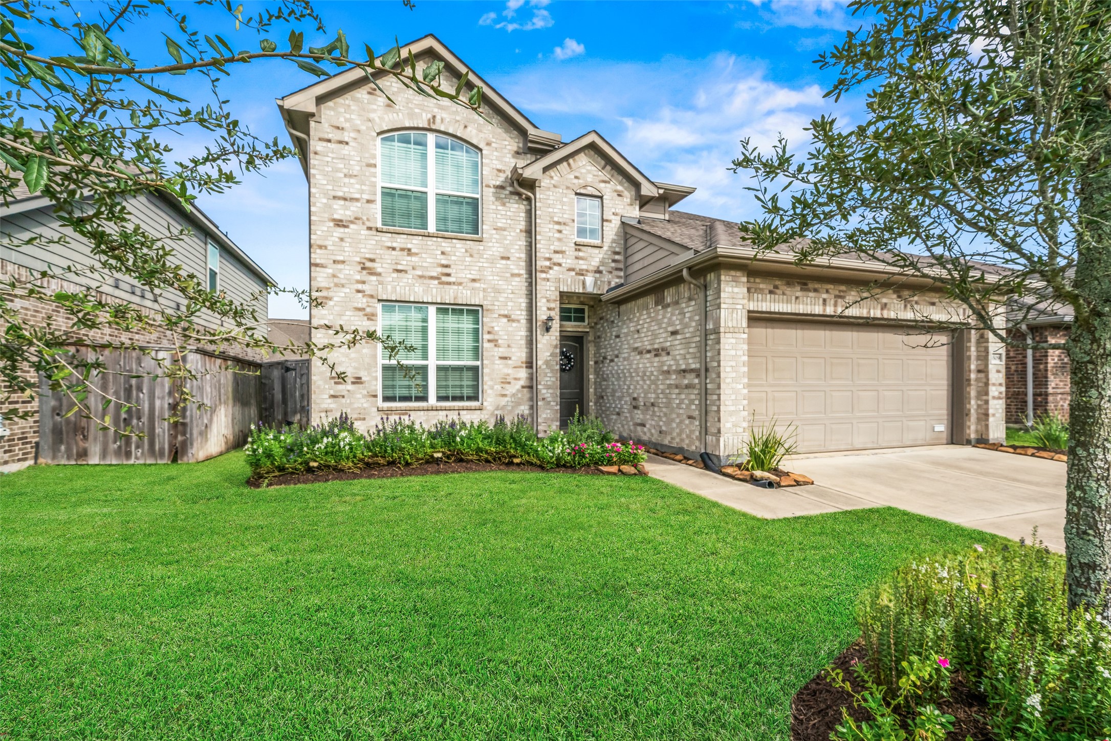Charming two-story brick home with a neatly landscaped front yard and a spacious two-car garage. Charming two-story brick home with a neatly landscaped front yard and a spacious two-car garage.