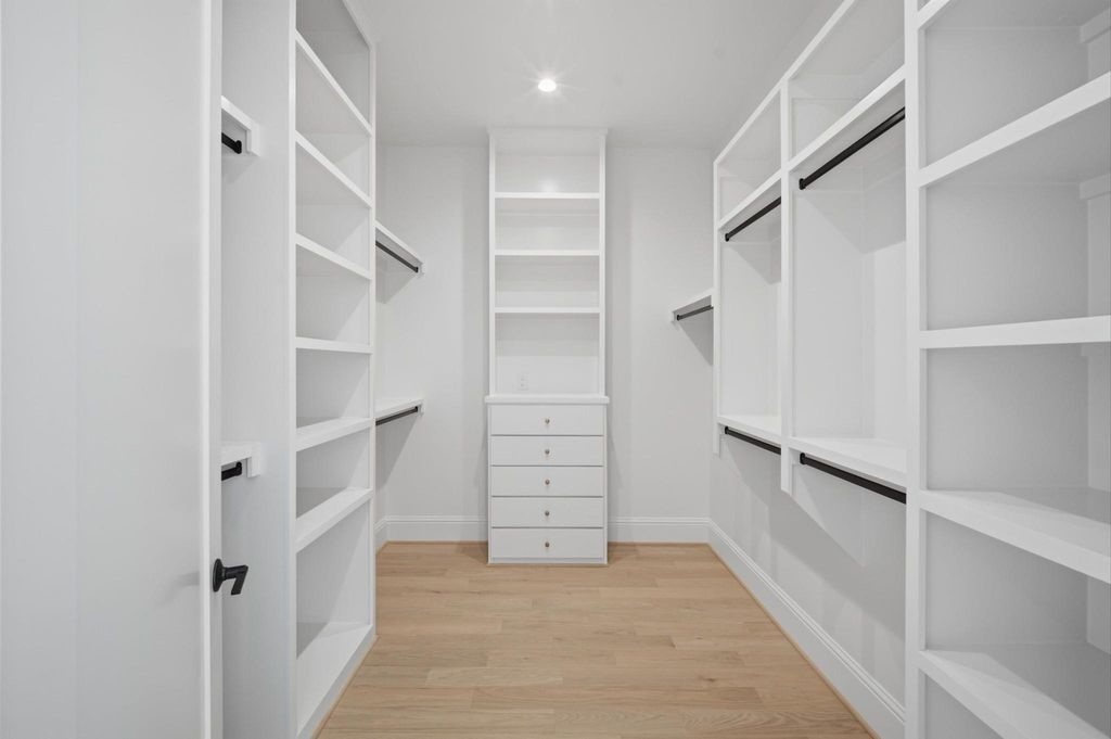 Primary walk-in closet with custom built-ins.