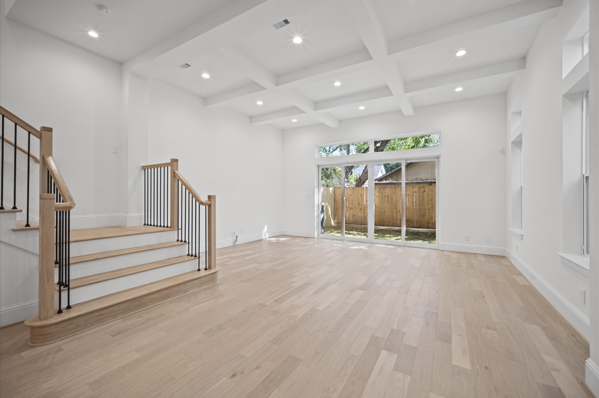 First-floor living with 12 ft ceilings and sliding glass doors into the backyard.