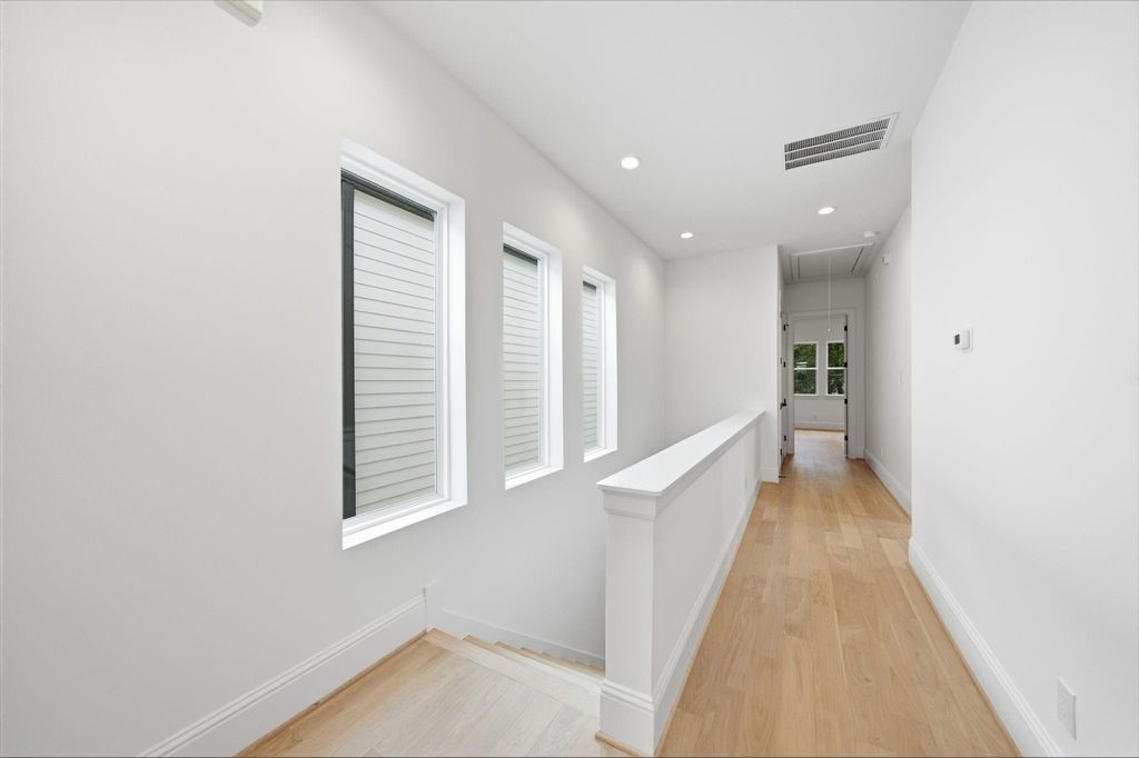 Bright upstairs hallway connecting the bedrooms.