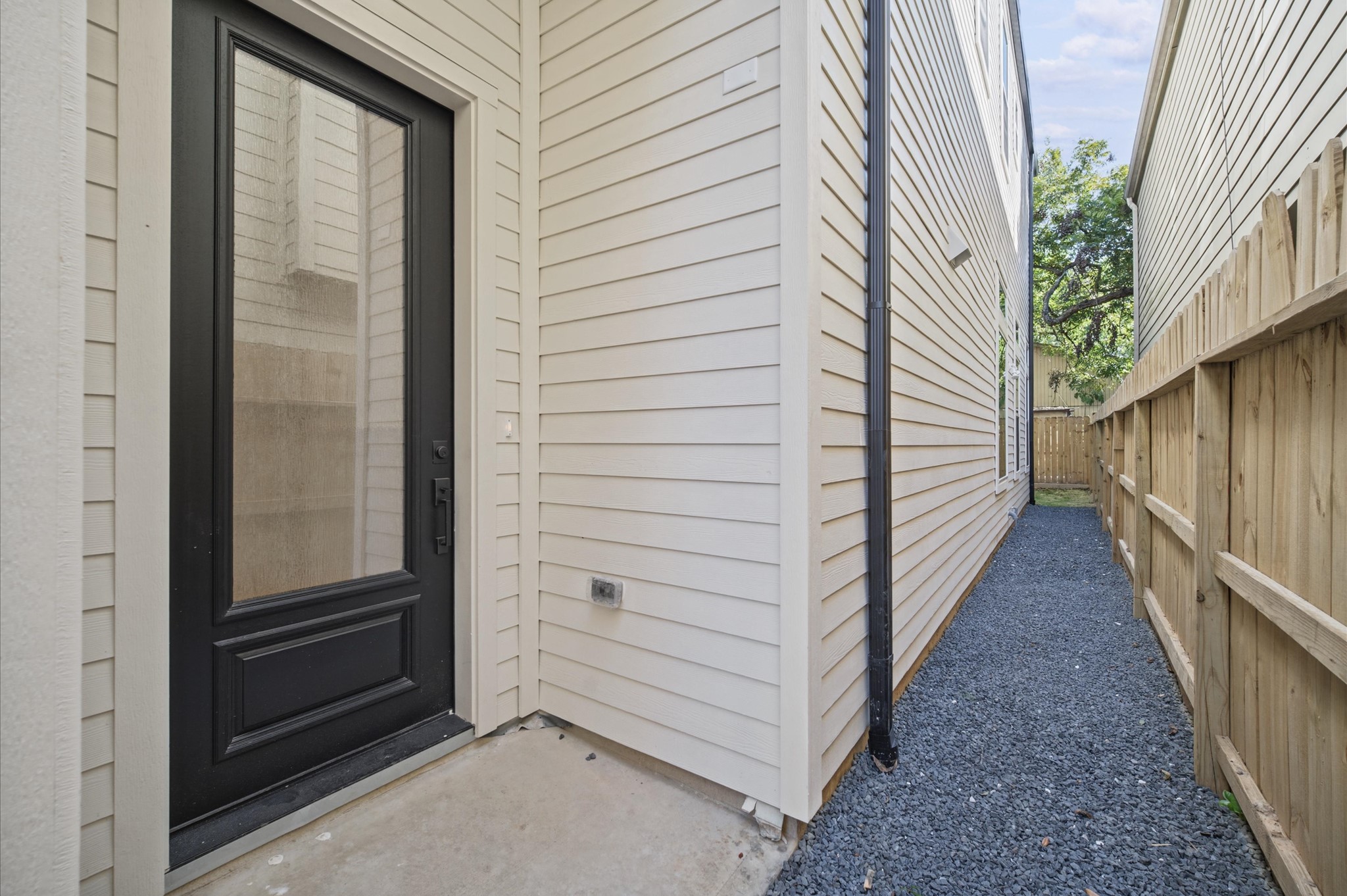Covered front entry with access to the backyard.