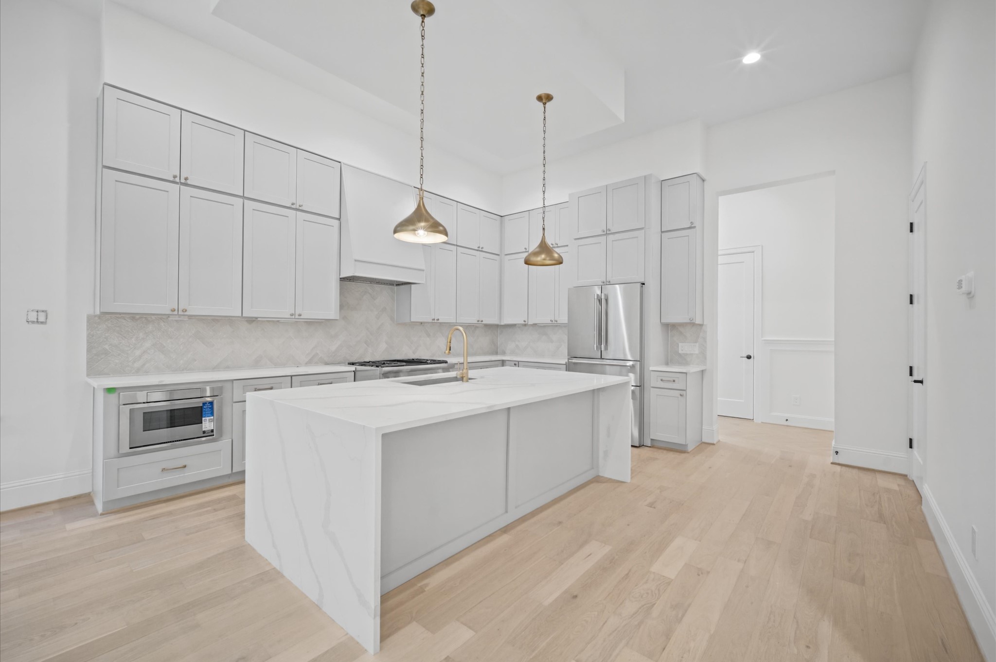 Chef's kitchen includes a pre-installed fridge and Thermador stainless steel appliances.