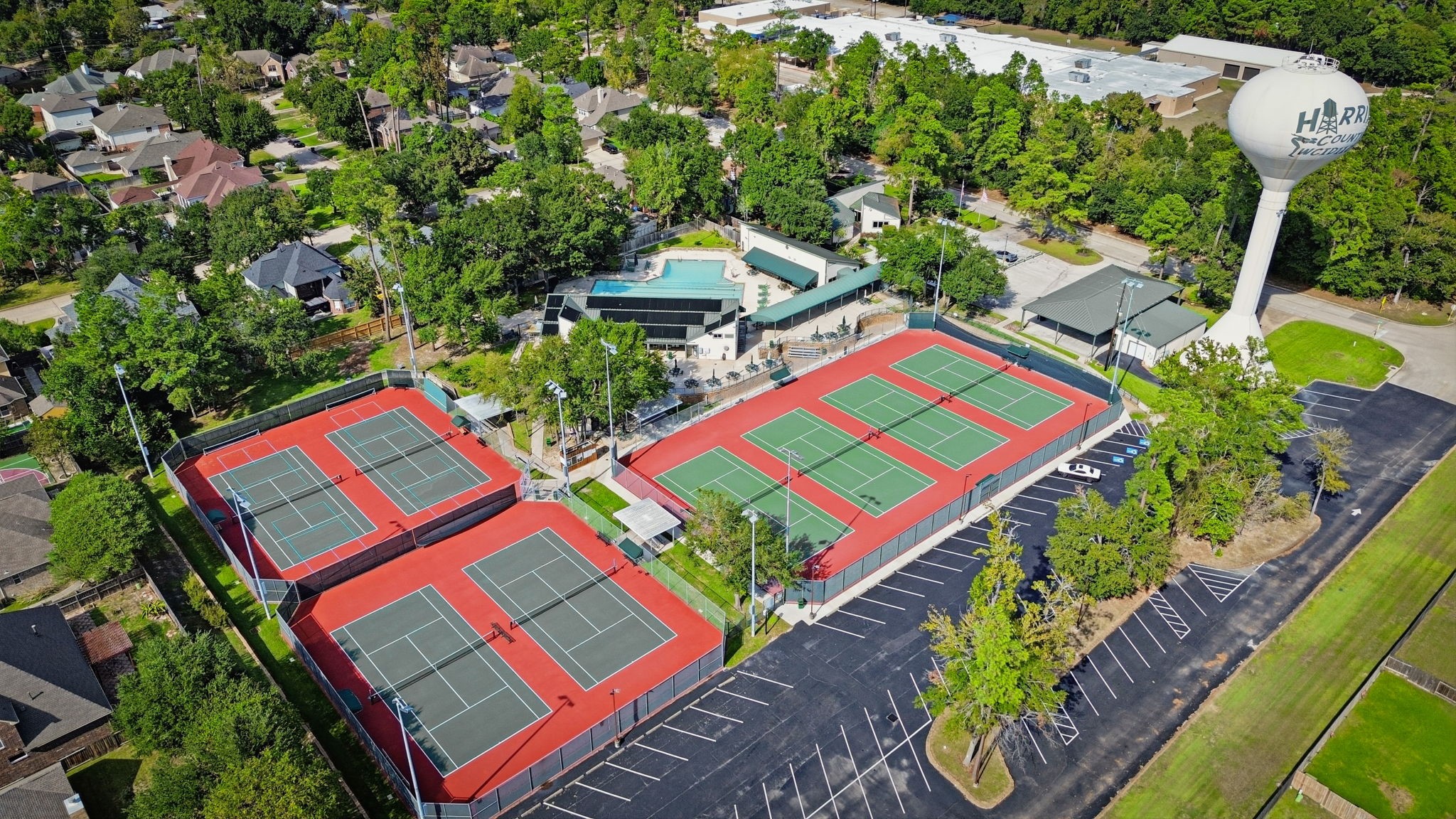 Enjoy resort-style amenities with multiple tennis courts, a large swimming pool complex, and lush surroundings in a well-maintained community setting.