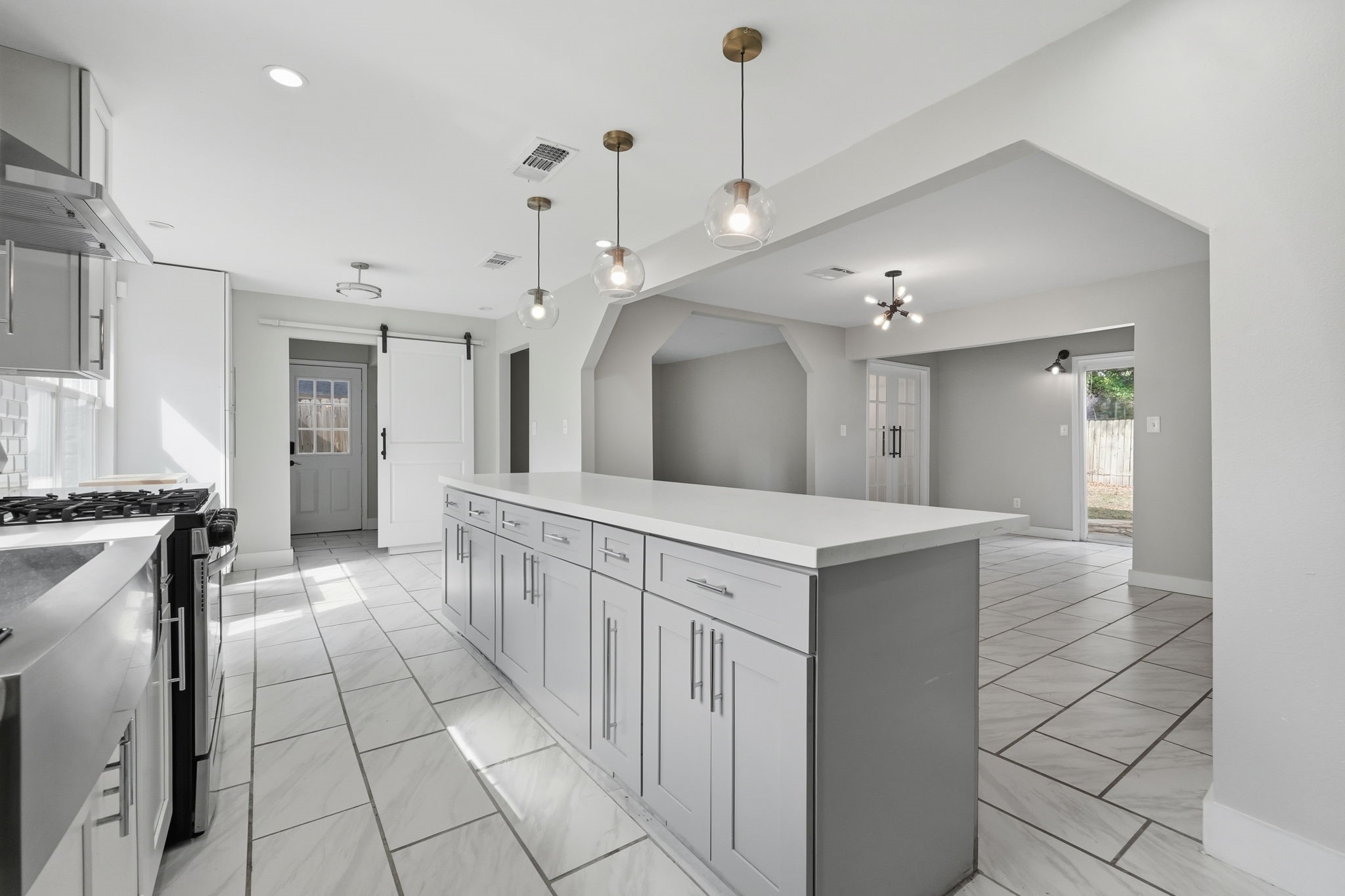 Bright and spacious kitchen provides a convenient, open layout leading to the dining area.