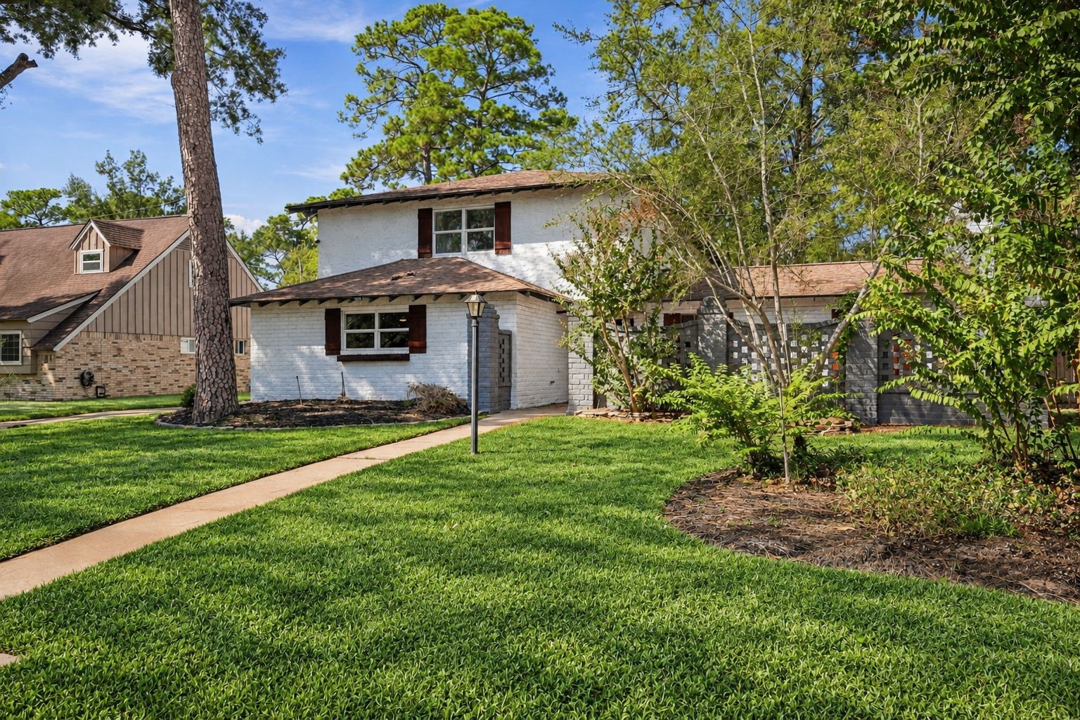 The walkway, greenery, and brick exterior all contribute to this house's great curb appeal.