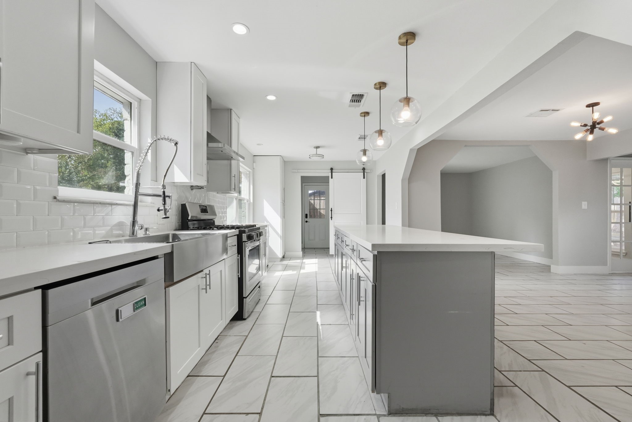 The large kitchen with a spacious island, seamlessly flows into the rest of the house.