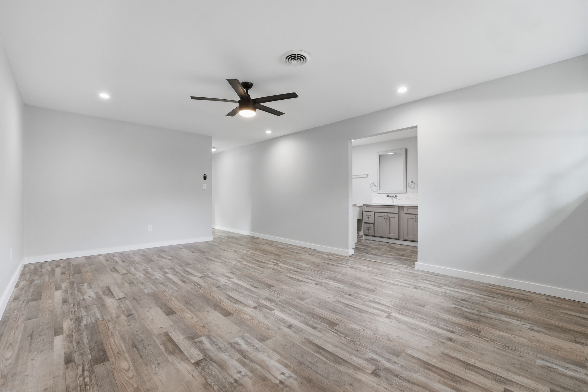 The primary bedroom has recessed lighting, open walkability, and seamlessly connects to the primary bathroom.