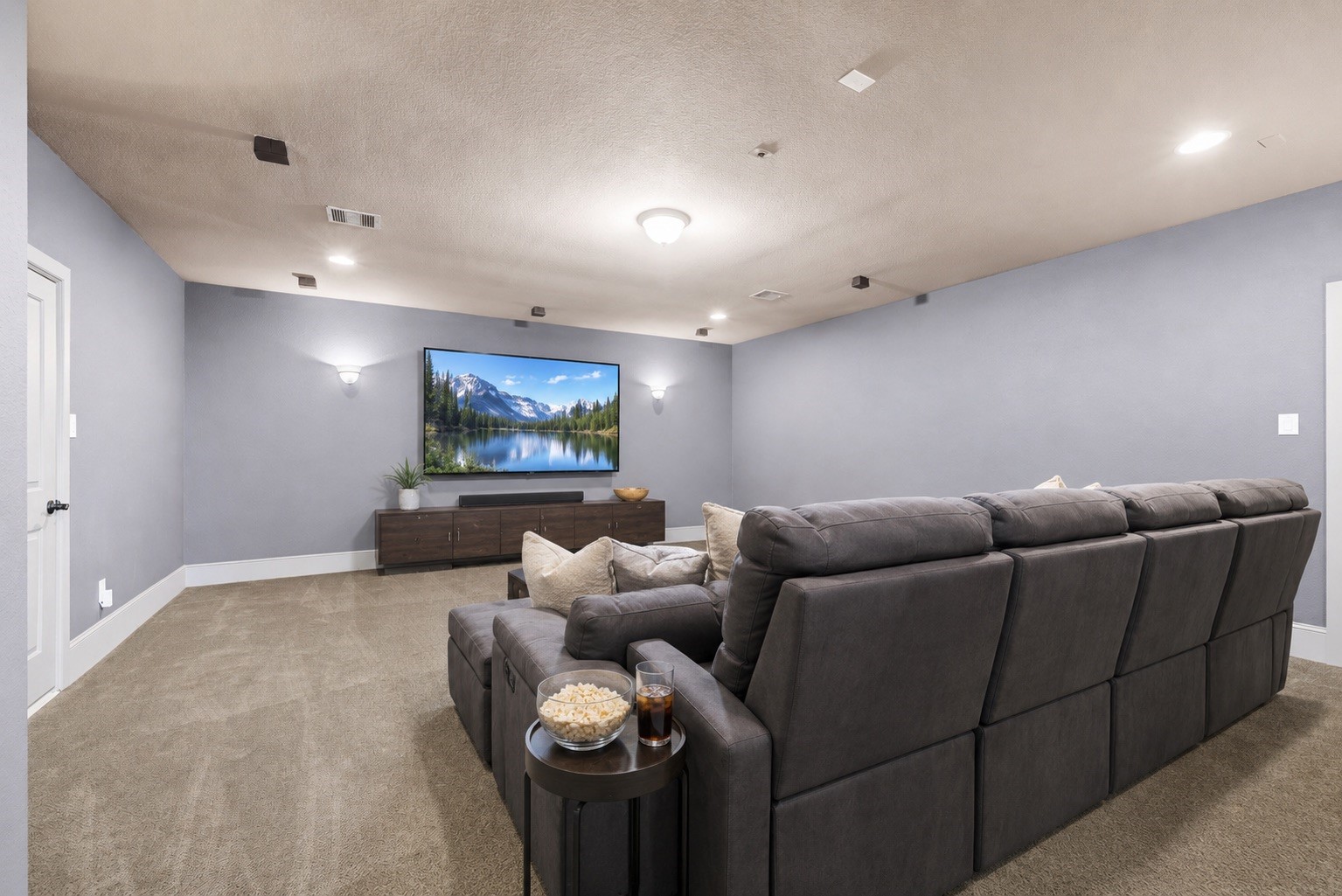 Huge Media Room with plush carpet and ambient lighting.