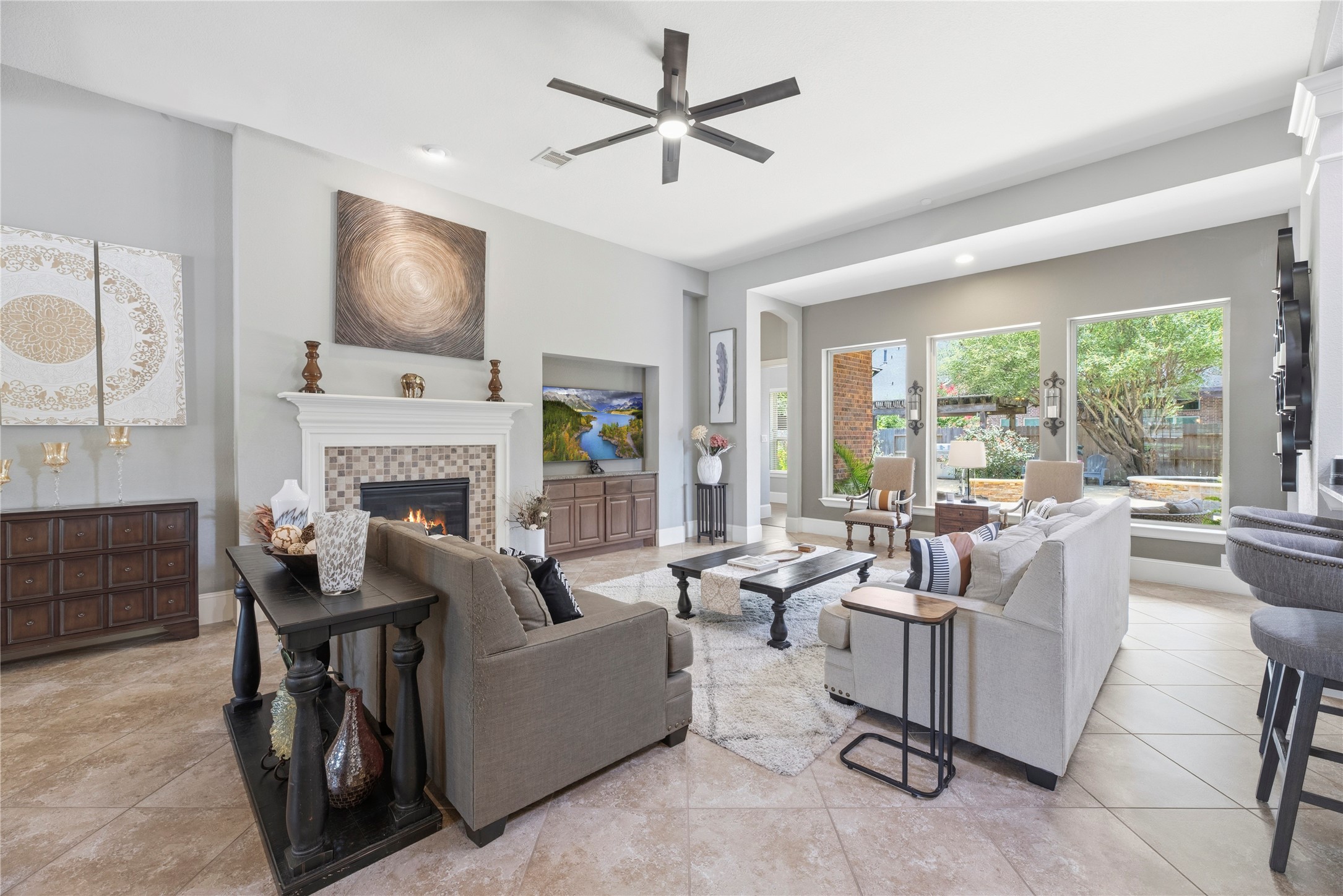 Spacious family room with large tile floors, gorgeous fireplace, and a complete energizing space.