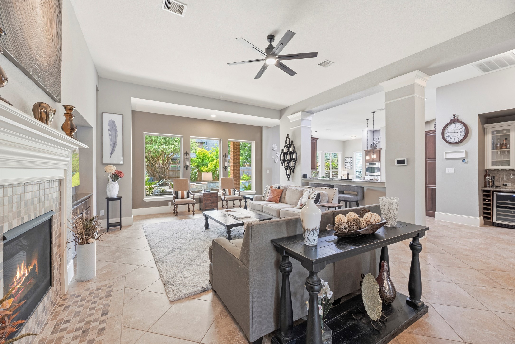 Spacious family room with large tile floors, gorgeous fireplace, and a complete energizing space.