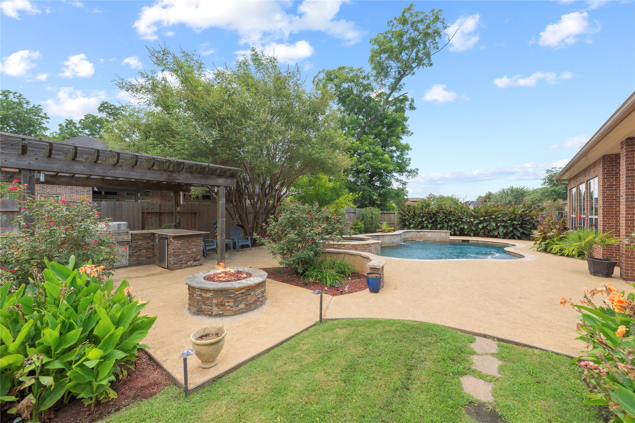 Welcome to your own private paradise, lush landscaping, sparkling pool, outdoor kitchen and much more.