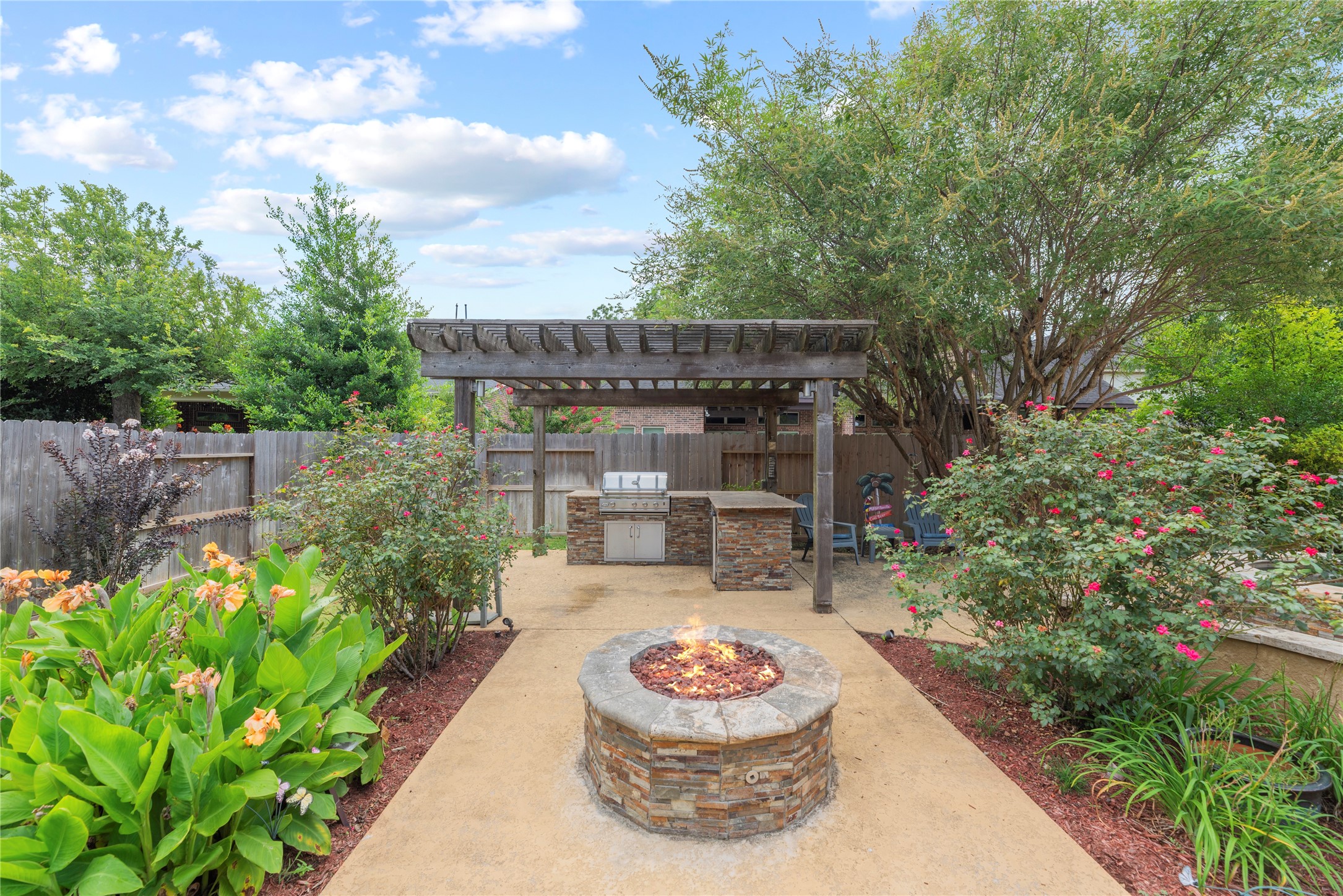 Outdoor kitchen and pergola + gas fire pit.