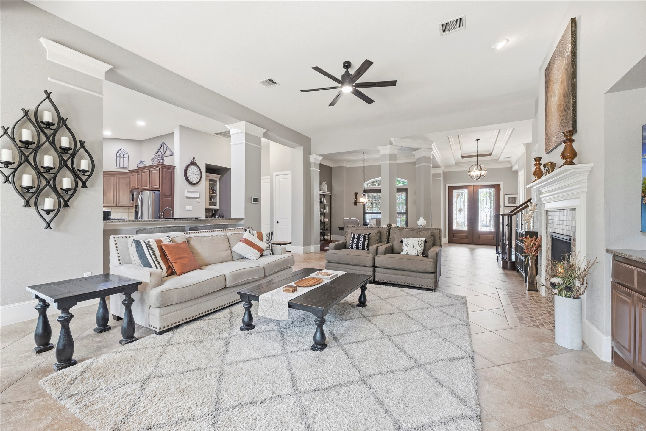 Spacious family room with large tile floors, gorgeous fireplace, and a complete energizing space.