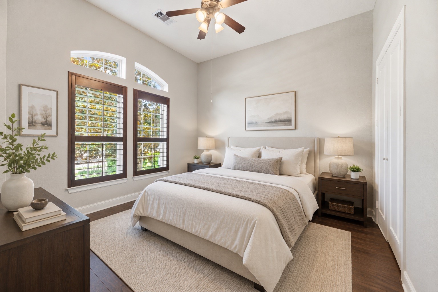 First Floor Guest Suite with a large walk-in closet, ceiling fan, and engineered wood floors.