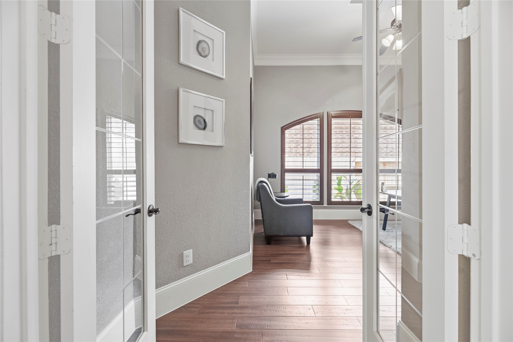 Through french doors in the front of the home is this grand home office