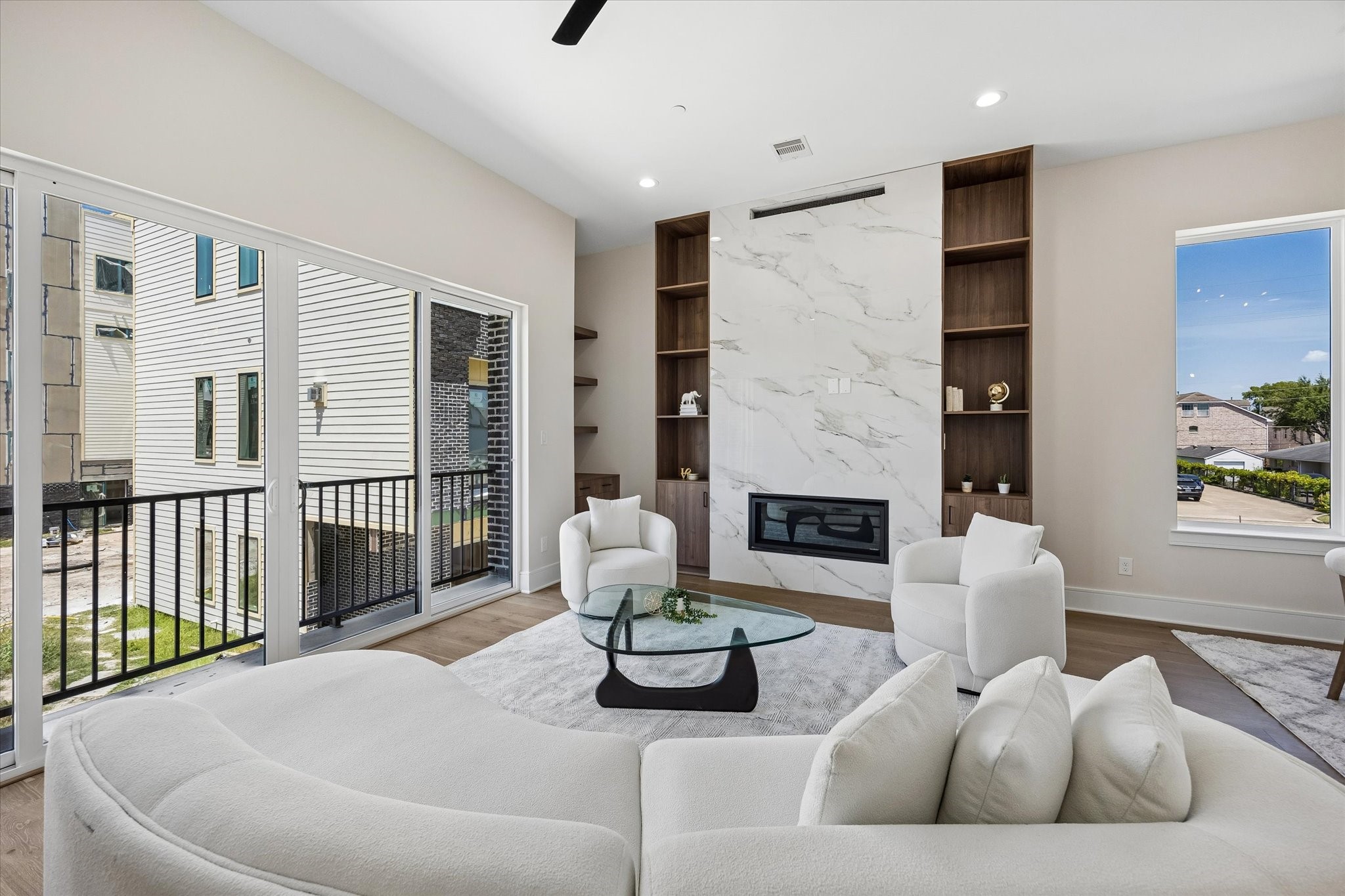 Spacious Living Room with floor to ceiling quartz fireplace surround and built-ins
