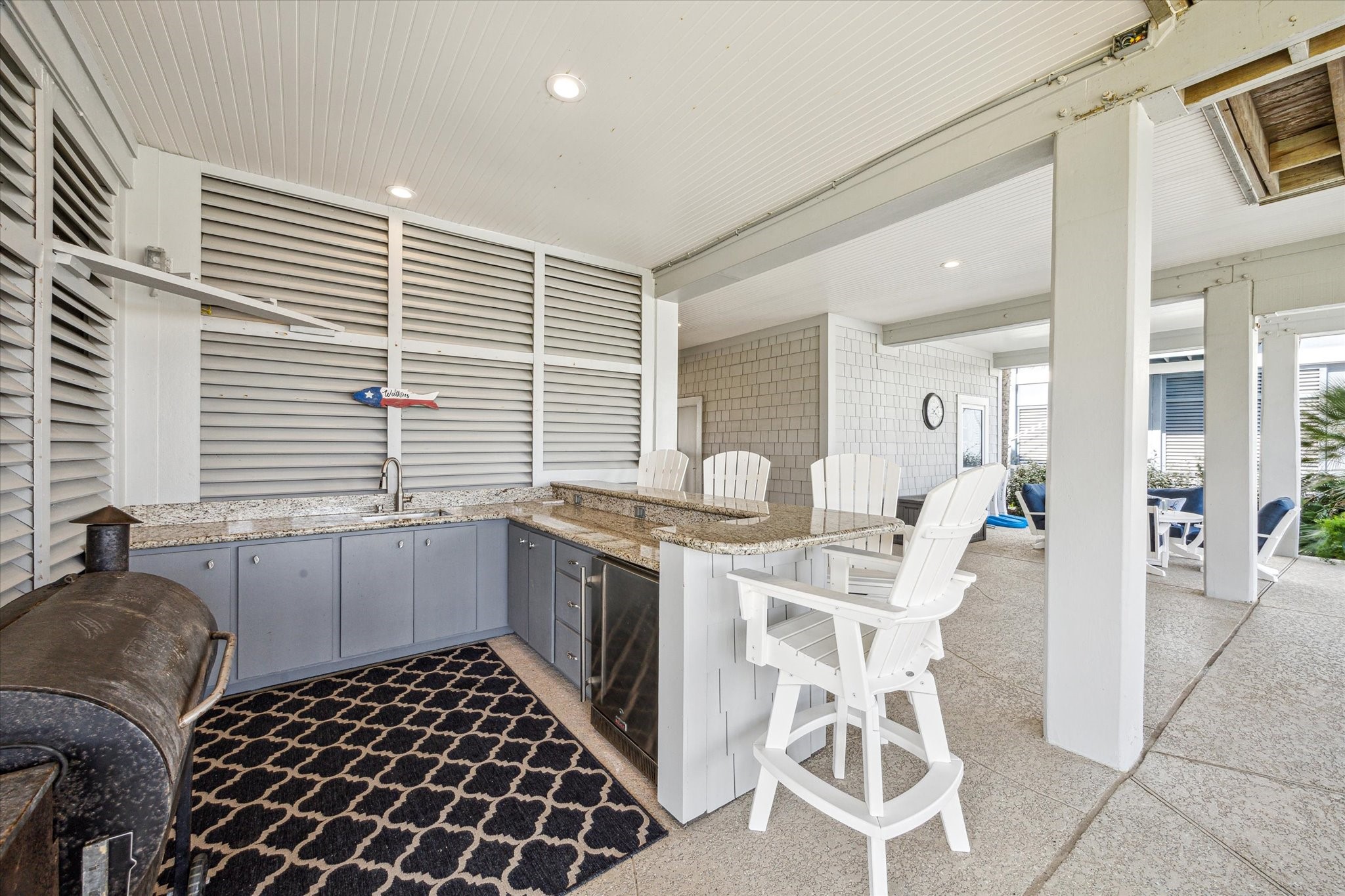 The ground level living area offers spacious serving area featuring granite countertops and a built-in undercabinet refrigerator and bar top for added convenience and easy of entertaining
