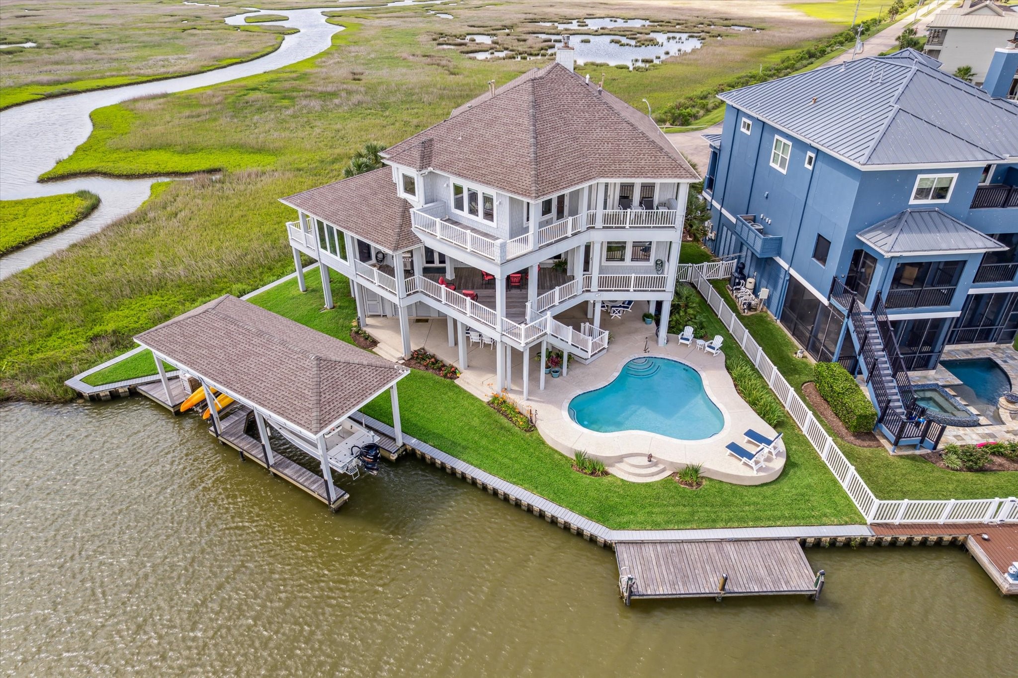 Located on a cul-de-sac, featuring expansive IPE decks, a resort-style pool, and over 140 ft. of waterfront with a 15x40 boathouse, dual lifts, fishing pier and 297 sq.ft. climate controlled tackle room on the ground level