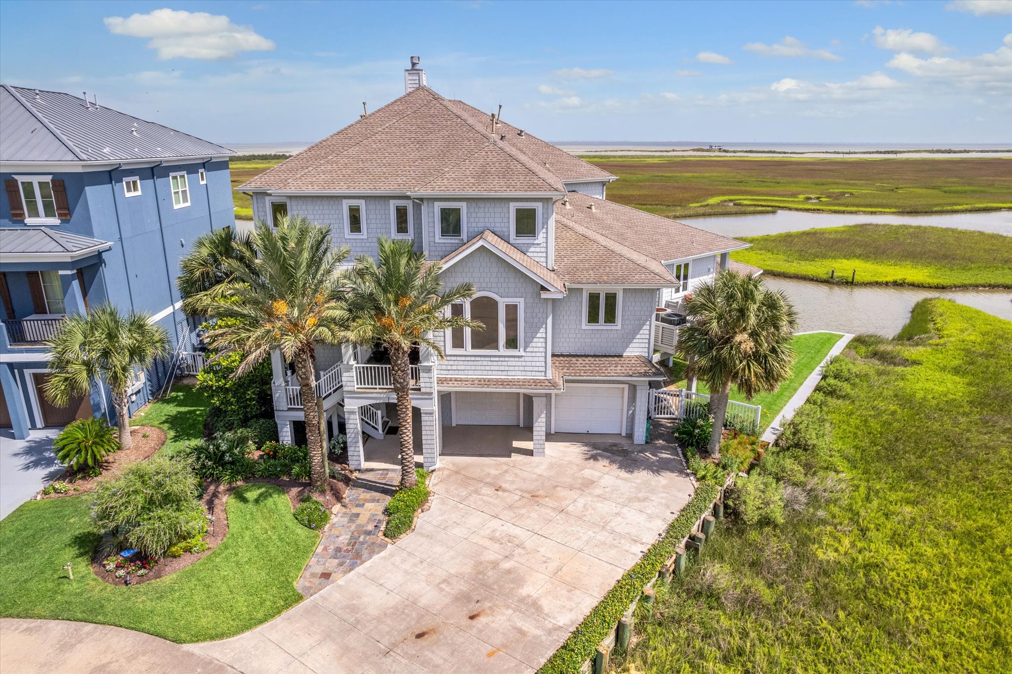 The manicured grounds and lush landscaping accented by landscape lighting enhance its curb appeal, making this a rare and exceptional offering on the Texas Gulf Coast