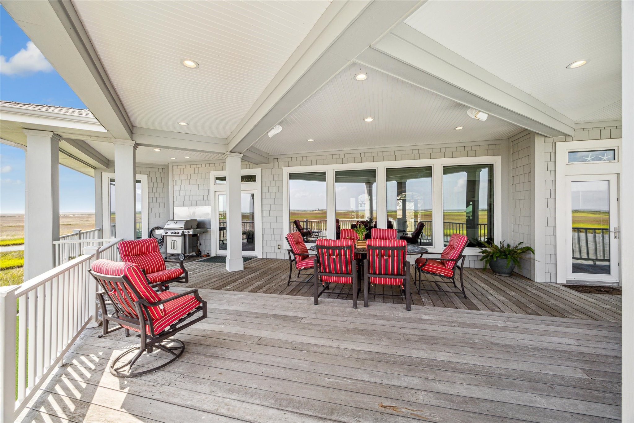 Just off the main living area, step into an expansive covered patio deck designed for true coastal living. This generous outdoor space easily accommodates all your favorite furnishingsperfect for lounging, dining, and entertaining in comfort